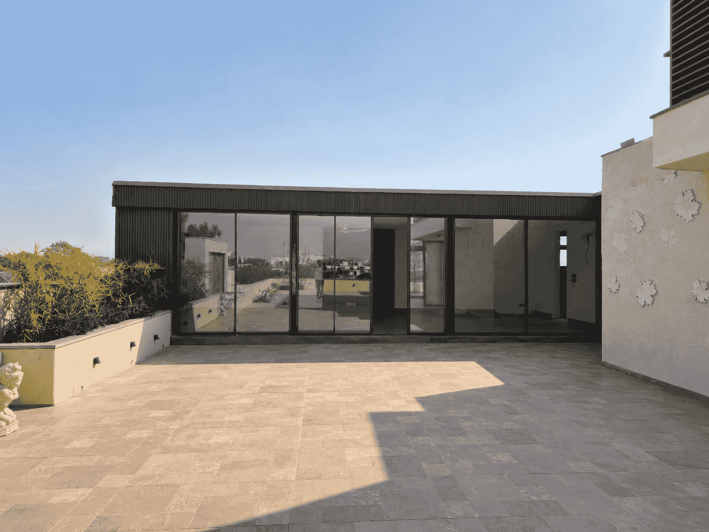 Terrace glass room with dark frame and insulated roof