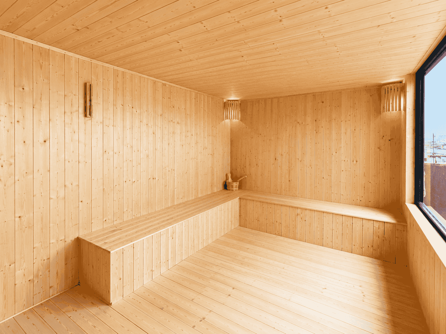 Timber-lined rooftop sauna room inside a prefab enclosure